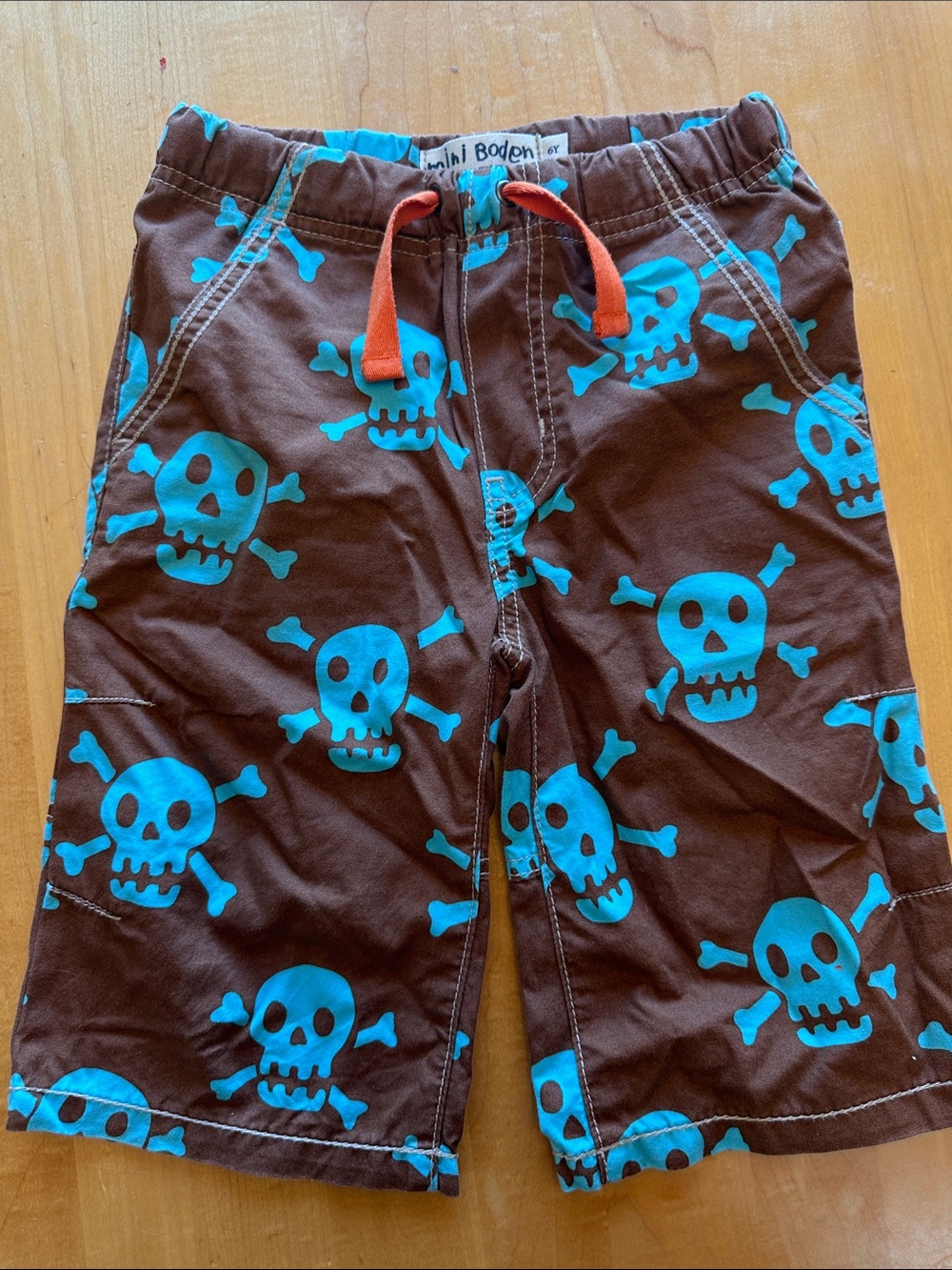 Mini Boden Brown Shorts with Bright Turquoise Skull Print and Orange Drawstring
